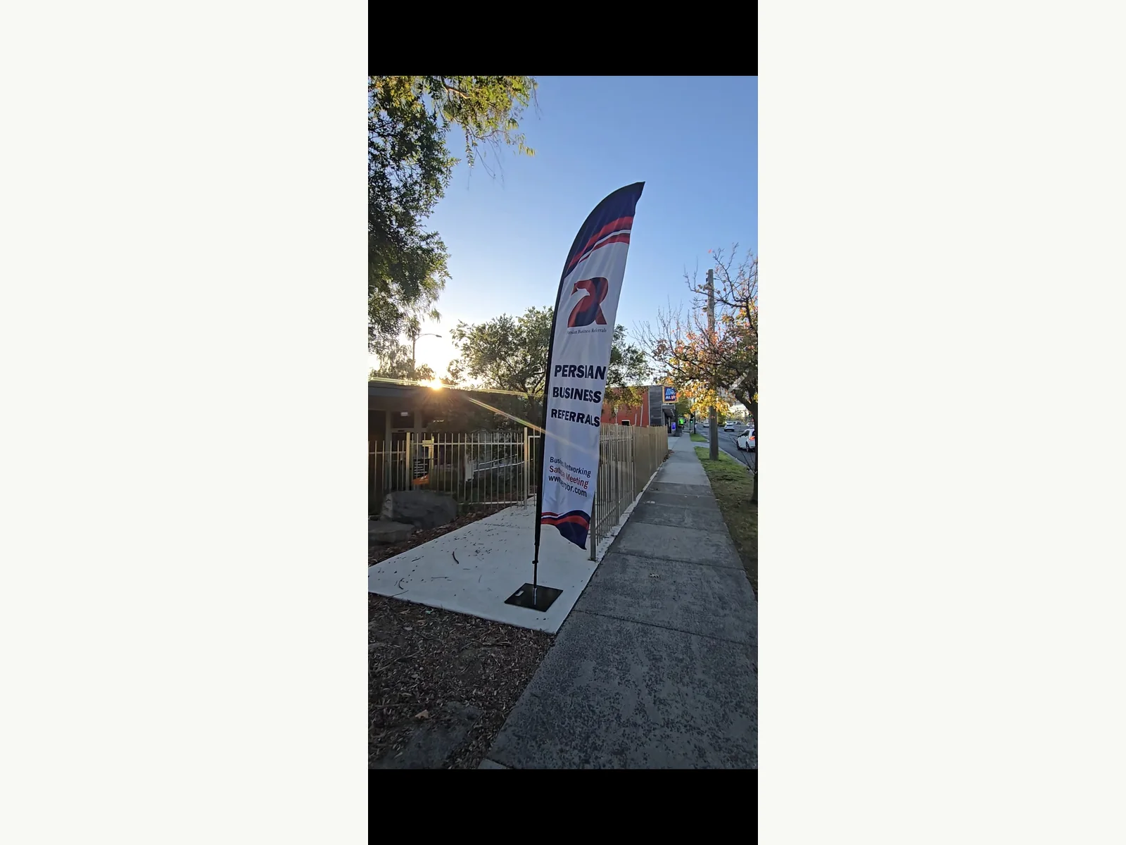 Printed promotional flag on outdoor footpath